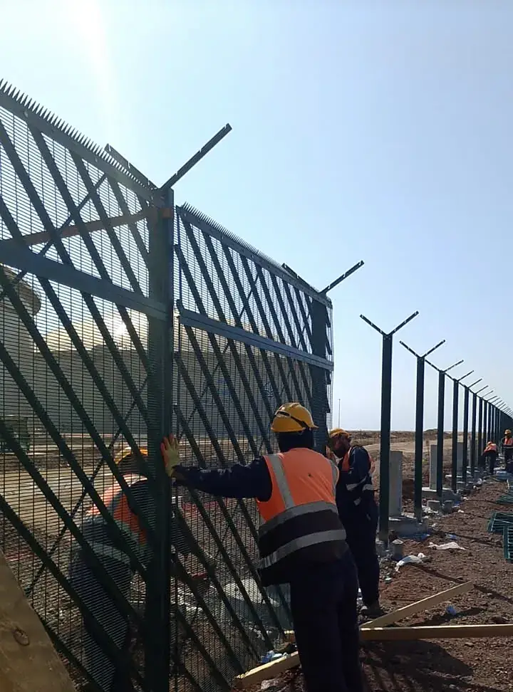 Welded mesh fence panels under installation